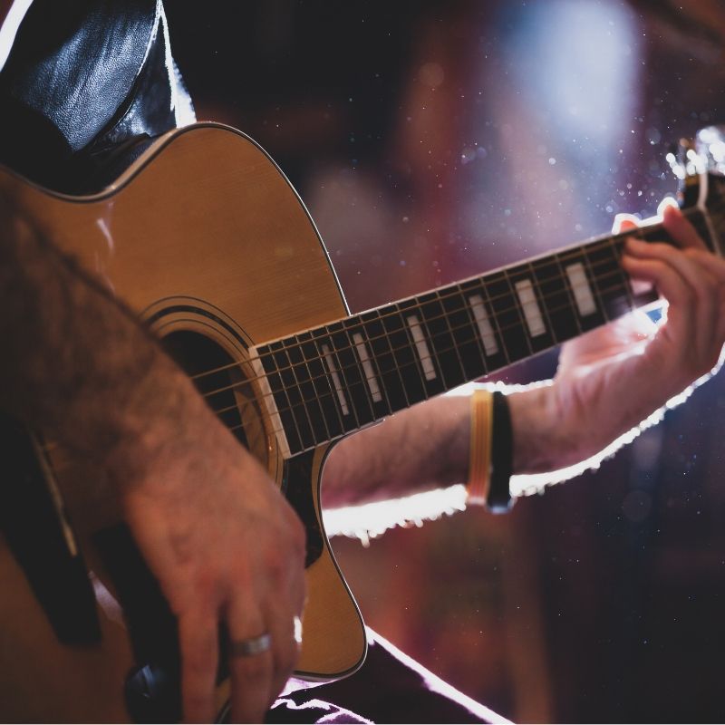 A musician playing acoustic guitar
