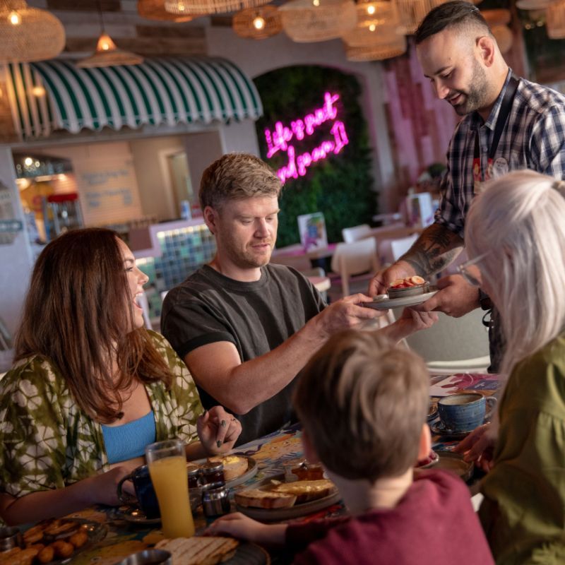 A family being served breakfast at the Pier House